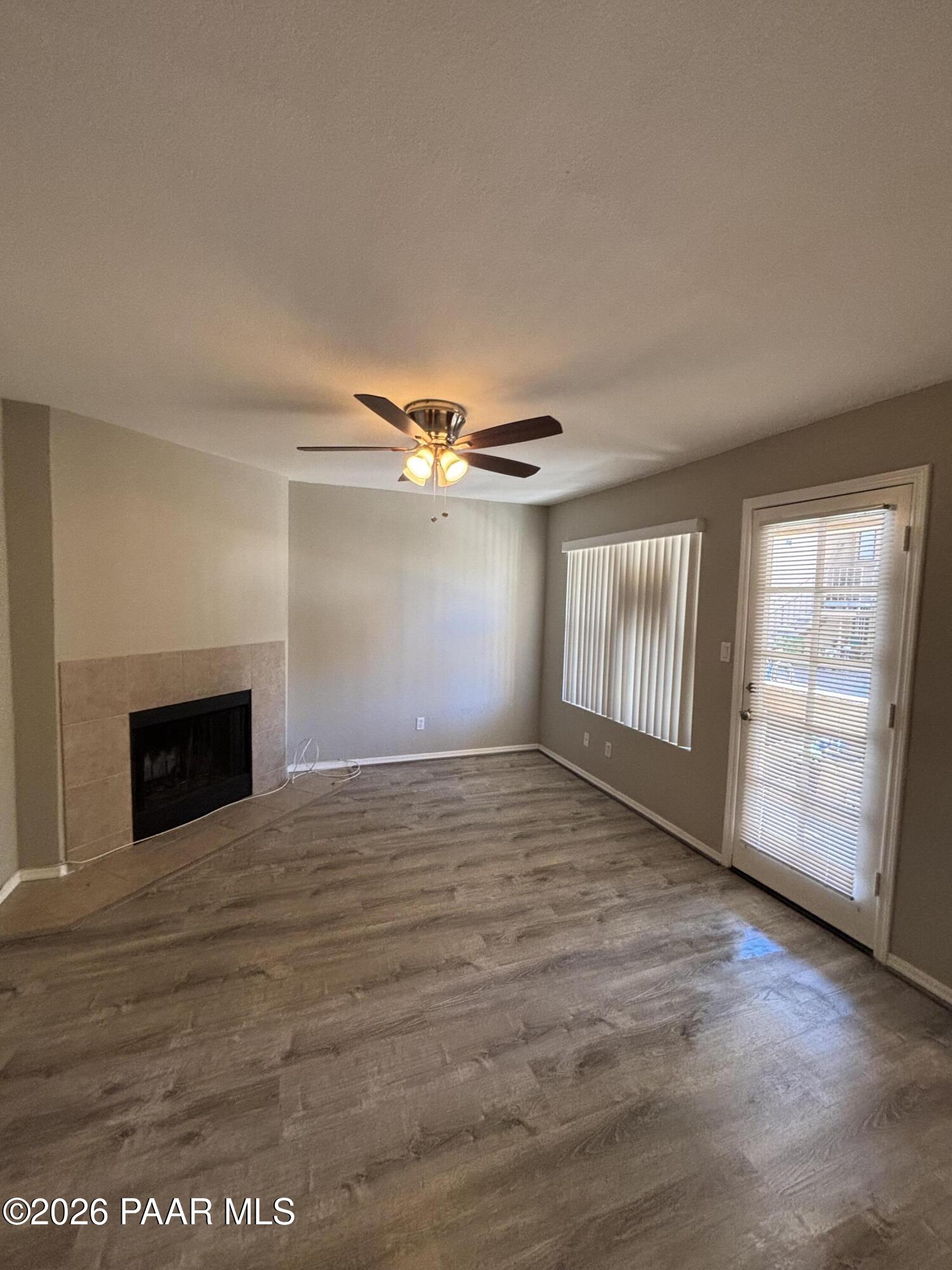 8787 East Mountain View Road, Unit 1082 Scottsdale, AZ 85258 - Photo 15 of 46 an empty room with windows and fireplace