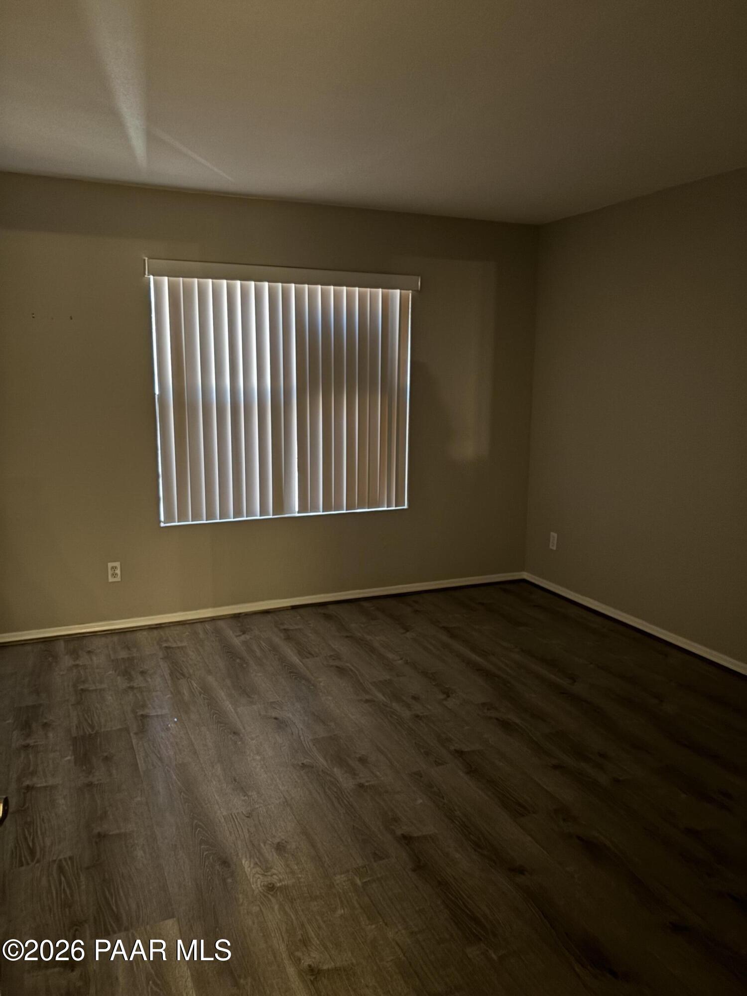 8787 East Mountain View Road, Unit 1082 Scottsdale, AZ 85258 - Photo 18 of 46 an empty room with wooden floor and windows