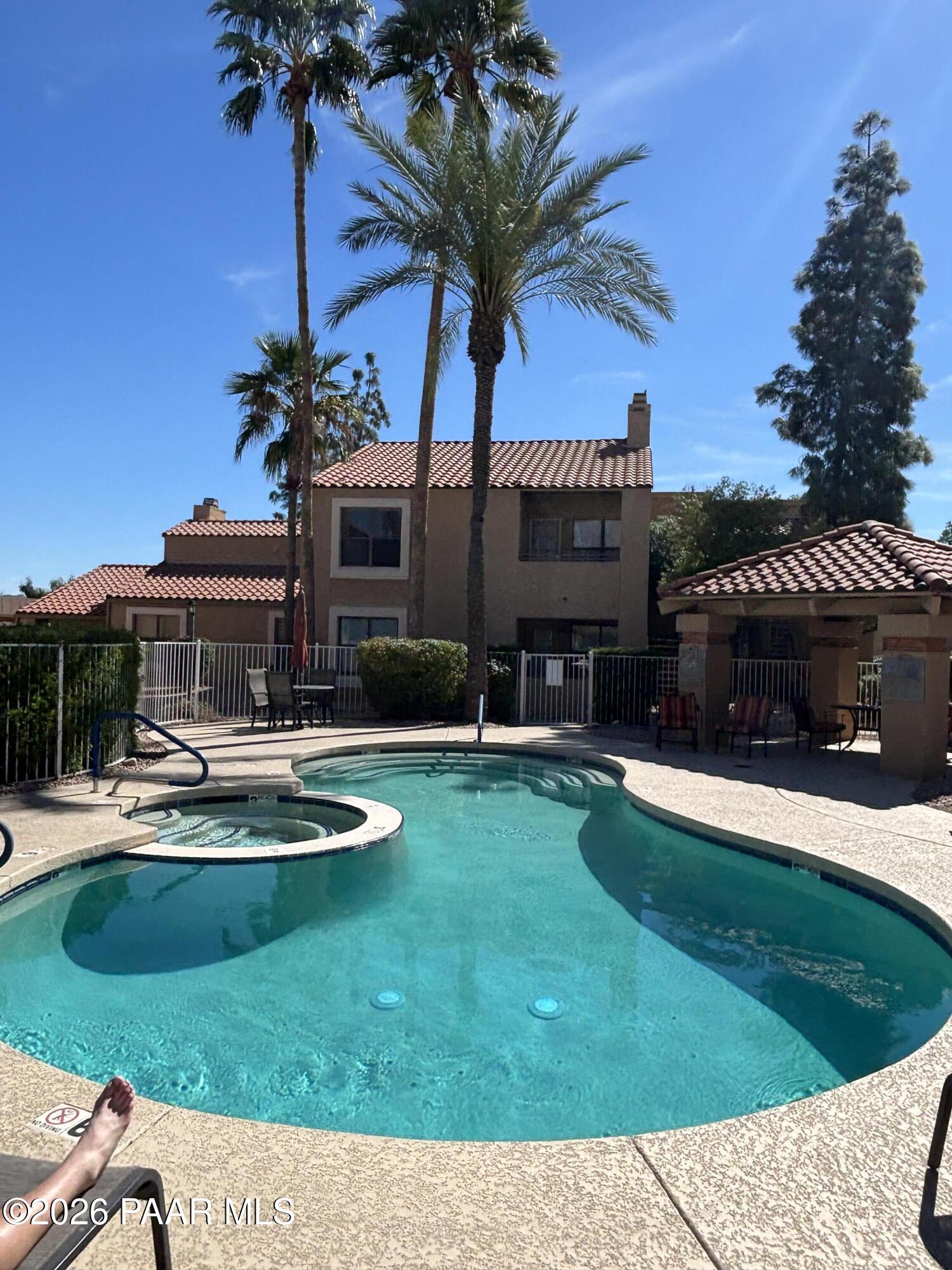 8787 East Mountain View Road, Unit 1082 Scottsdale, AZ 85258 - Photo 2 of 46 a view of a house with swimming pool and a yard