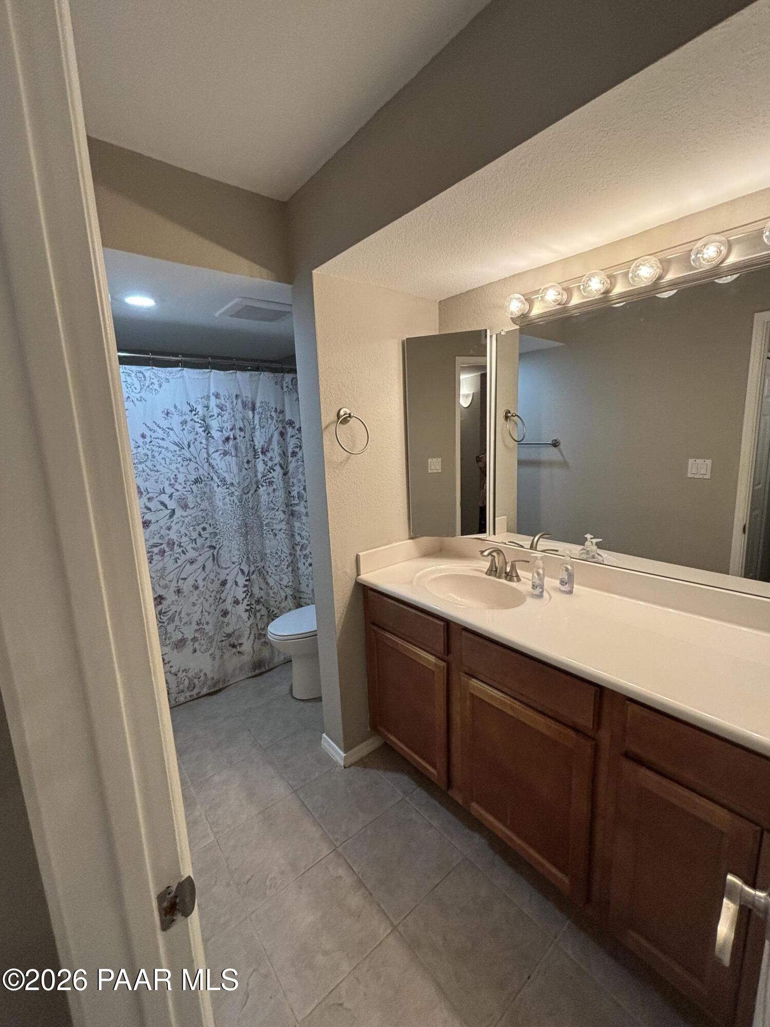 8787 East Mountain View Road, Unit 1082 Scottsdale, AZ 85258 - Photo 23 of 46 a bathroom with a sink a toilet and shower
