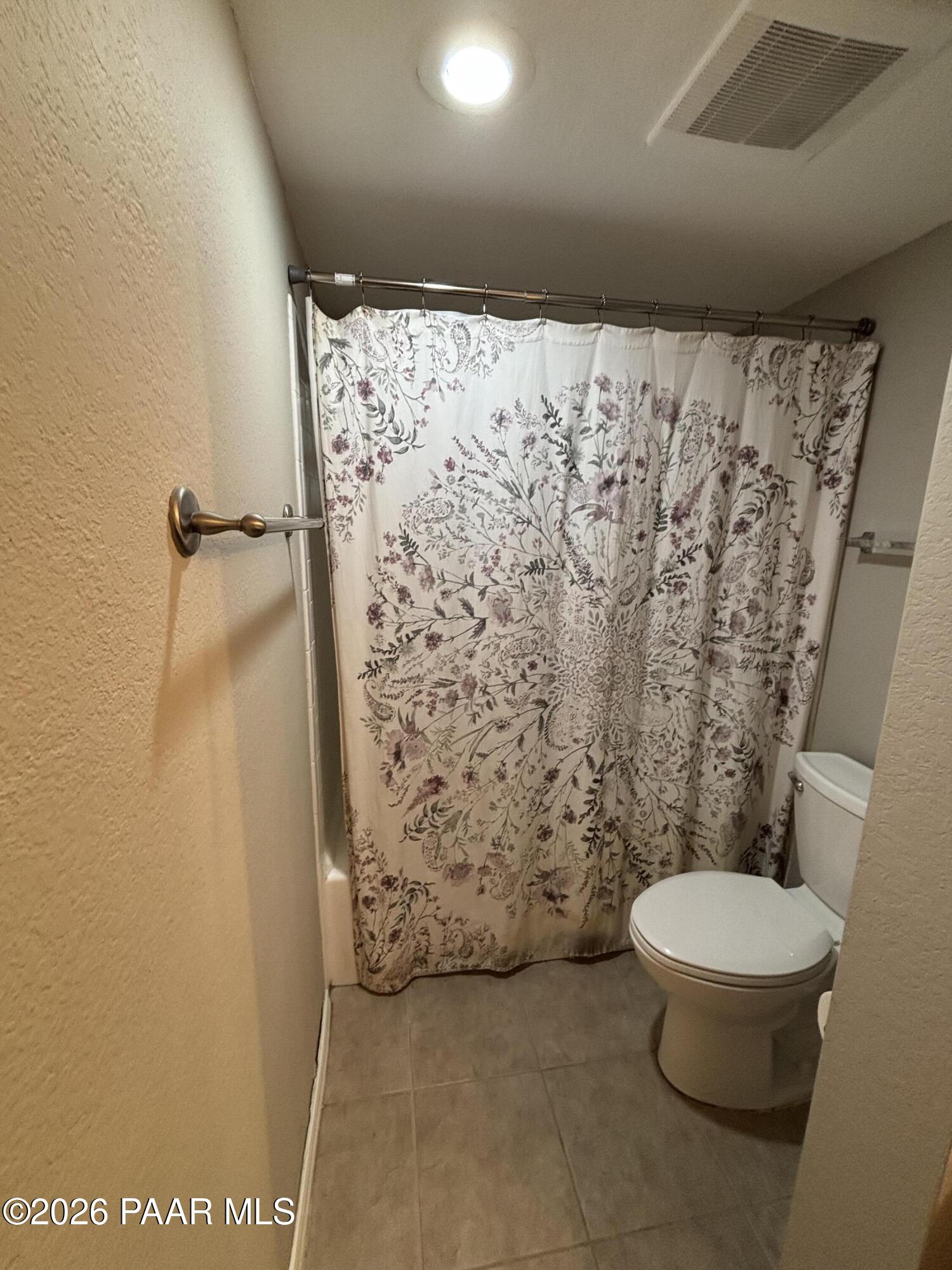 8787 East Mountain View Road, Unit 1082 Scottsdale, AZ 85258 - Photo 24 of 46 a bathroom with a toilet and a shower curtain