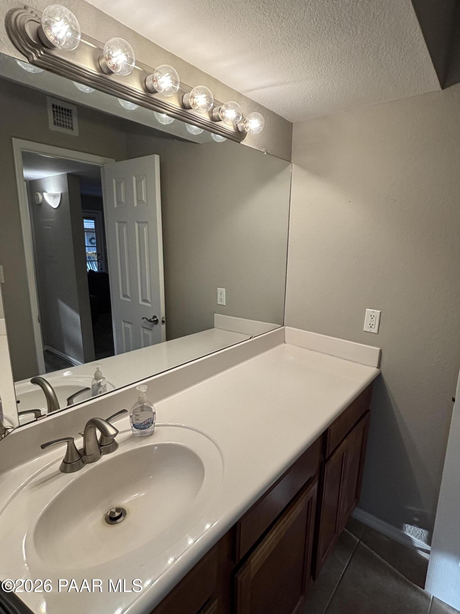 8787 East Mountain View Road, Unit 1082 Scottsdale, AZ 85258 - Photo 26 of 46 a bathroom with a sink and a mirror