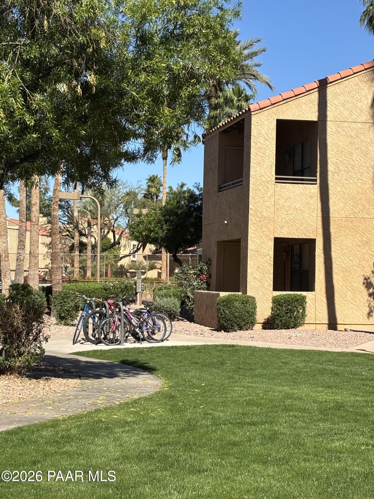 8787 East Mountain View Road, Unit 1082 Scottsdale, AZ 85258 - Photo 32 of 46 a front view of a house with garden