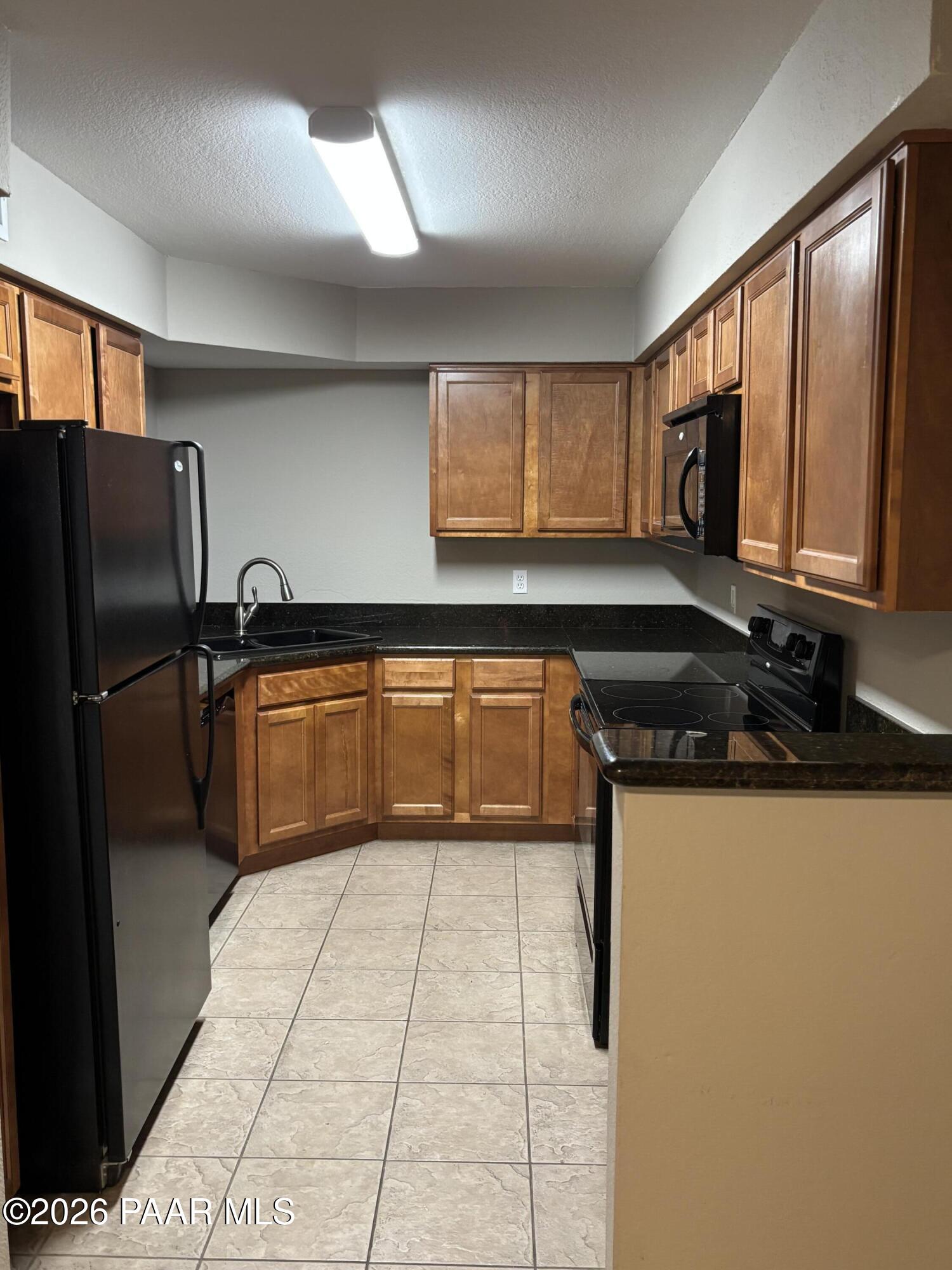 8787 East Mountain View Road, Unit 1082 Scottsdale, AZ 85258 - Photo 7 of 46 a kitchen with stainless steel appliances a refrigerator sink and cabinets