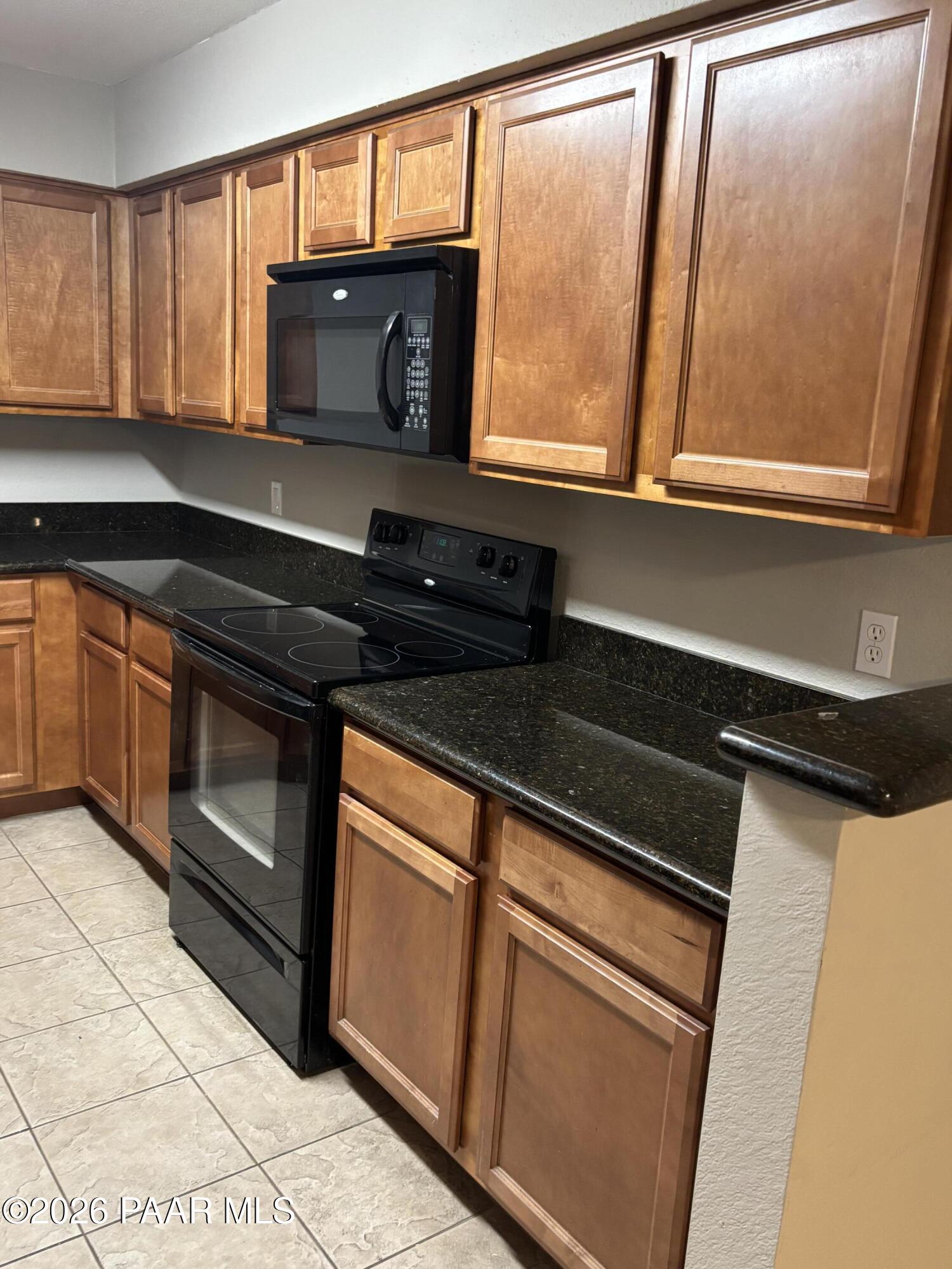 8787 East Mountain View Road, Unit 1082 Scottsdale, AZ 85258 - Photo 8 of 46 a kitchen with granite countertop cabinets stainless steel appliances and a window