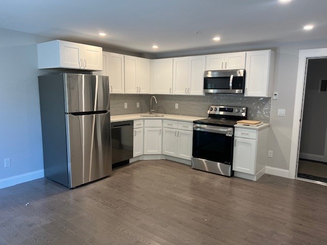 328 Bank Street, Unit 5 Harwich, MA 02645 - Photo 1 of 7 a kitchen with stainless steel appliances granite countertop a refrigerator stove a sink and a microwave