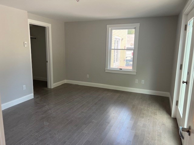 328 Bank Street, Unit 5 Harwich, MA 02645 - Photo 3 of 7 an empty room with wooden floor and windows