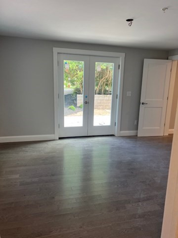 328 Bank Street, Unit 5 Harwich, MA 02645 - Photo 6 of 7 an empty room with wooden floor and windows