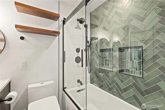 a bathroom with a shower and toilet