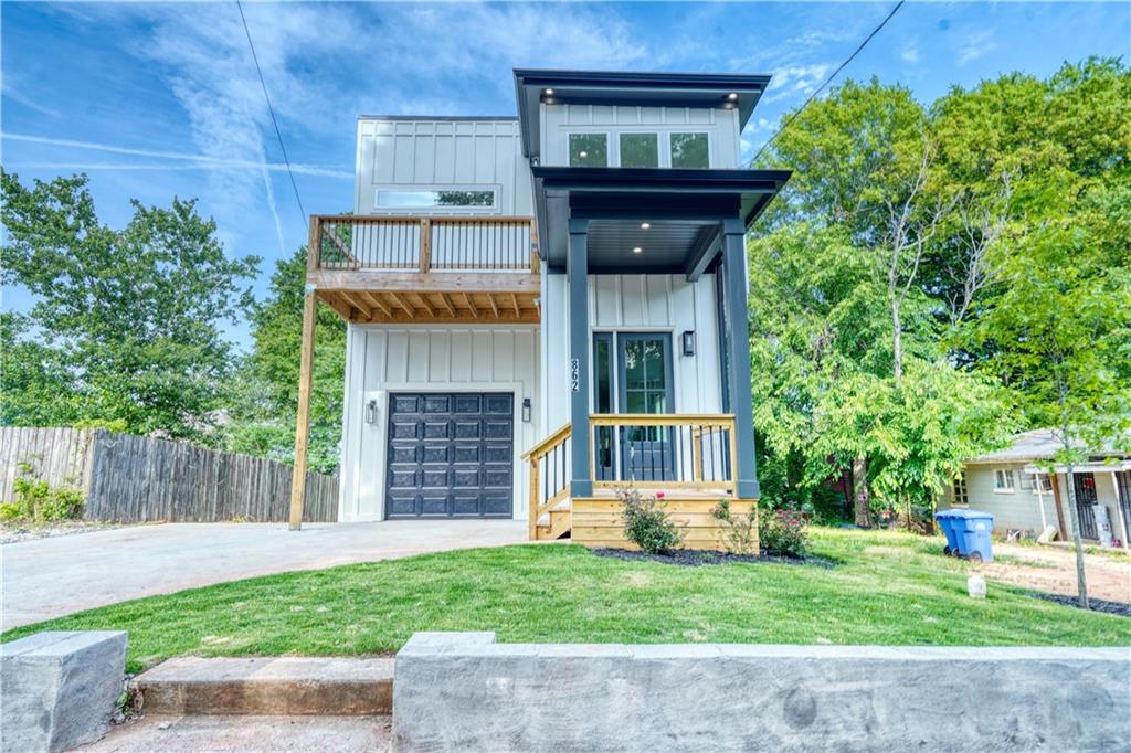 862 Hobson Street Southwest Atlanta, GA 30310 - Photo 1 of 1 a view of a house with a small yard and a large tree