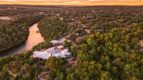 an aerial view of house with yard and mountain view in back