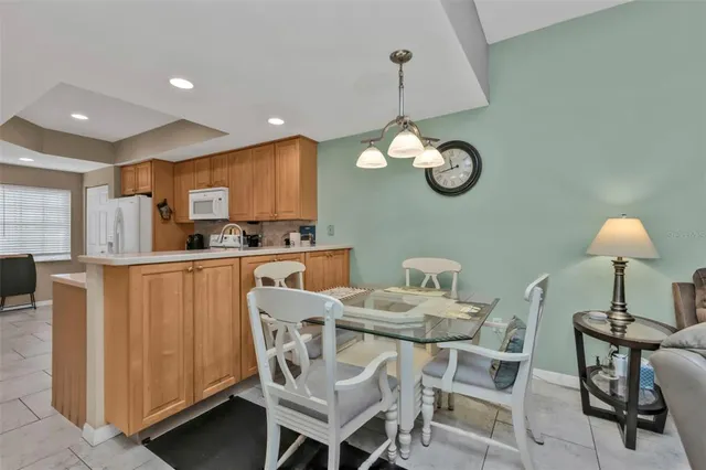 a dining room filled chandelier and wooden floor