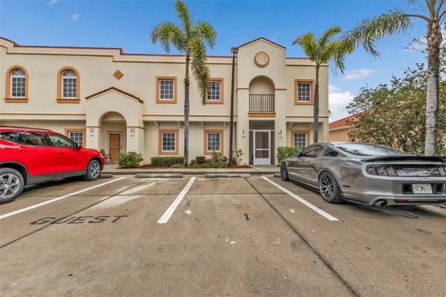 a couple of cars parked in front of a house