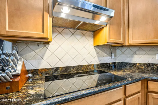 a kitchen with granite countertop a sink and cabinets