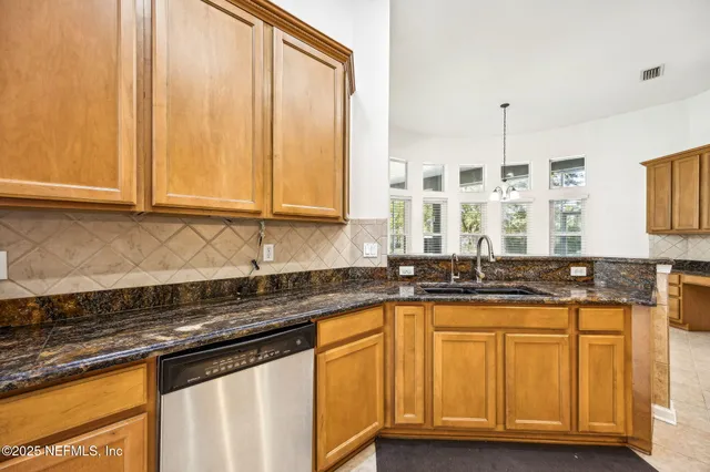 a kitchen with granite countertop a stove top oven