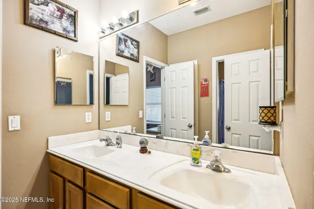 a bedroom with a bed and a tv on the dresser