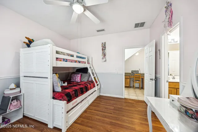 a view of staircase with wooden floor and white walls