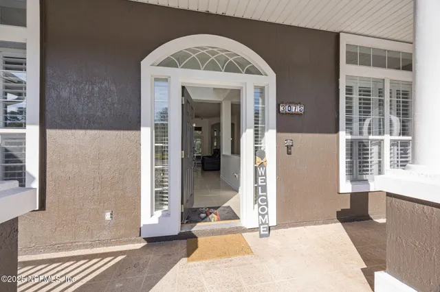 a view of a bedroom with wooden floor and windows