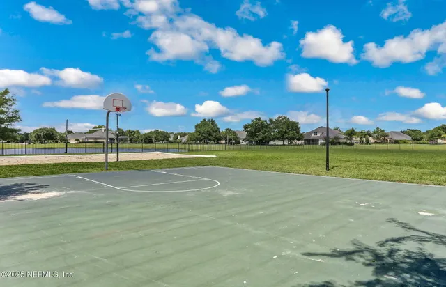 an aerial view of a house with a garden and lake view