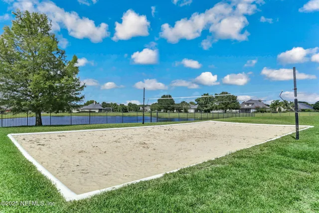 a view of house with backyard and garden