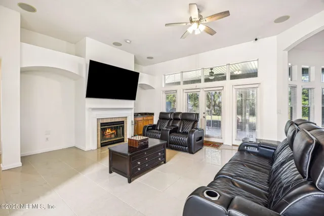 a living room with furniture a fireplace and a flat screen tv