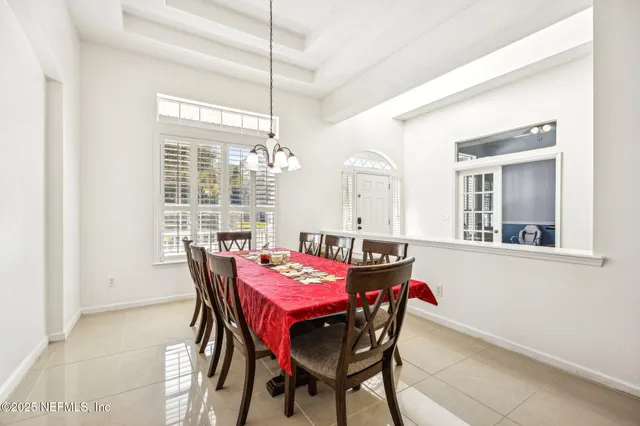 a view of a dining room with furniture and window