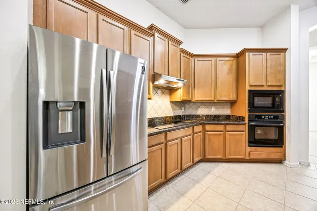 a kitchen with a sink a window and cabinets