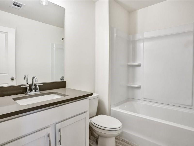 2539 Riverside Court Northeast Conyers, GA 30013 - Photo 14 of 31 a bathroom with a sink toilet vanity and bathtub