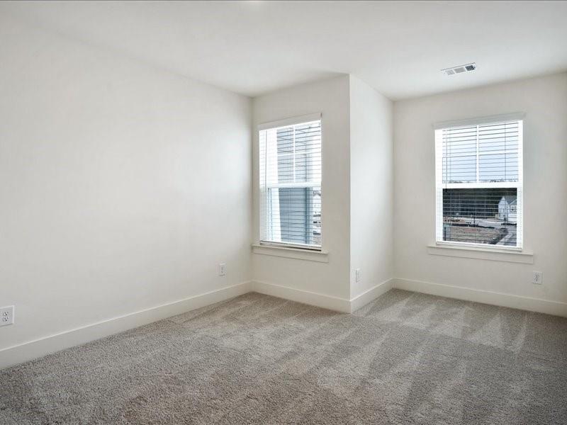 2539 Riverside Court Northeast Conyers, GA 30013 - Photo 19 of 31 an empty room with windows