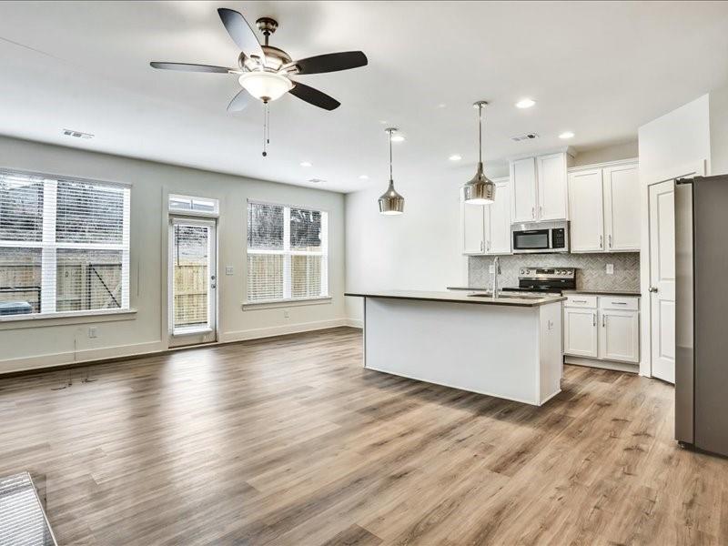2539 Riverside Court Northeast Conyers, GA 30013 - Photo 2 of 31 a kitchen with stainless steel appliances kitchen island granite countertop a stove a refrigerator a sink and a microwave