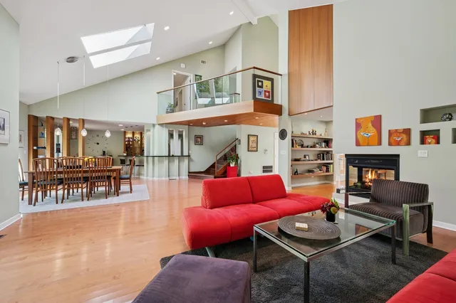 a living room with furniture a rug and a table