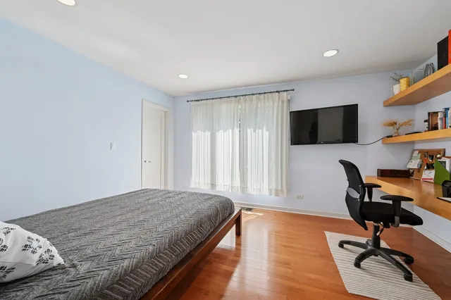 a bedroom with a bed and a desk