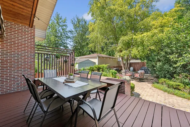 a view of a patio with table and chairs and potted plants