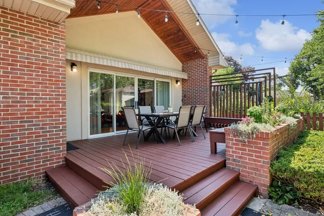 a view of a patio with table and chairs and potted plants