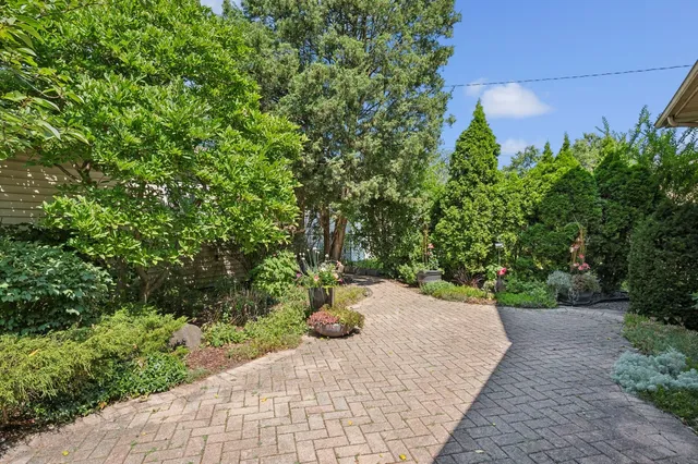 a view of a hallway with wooden floor and stairs
