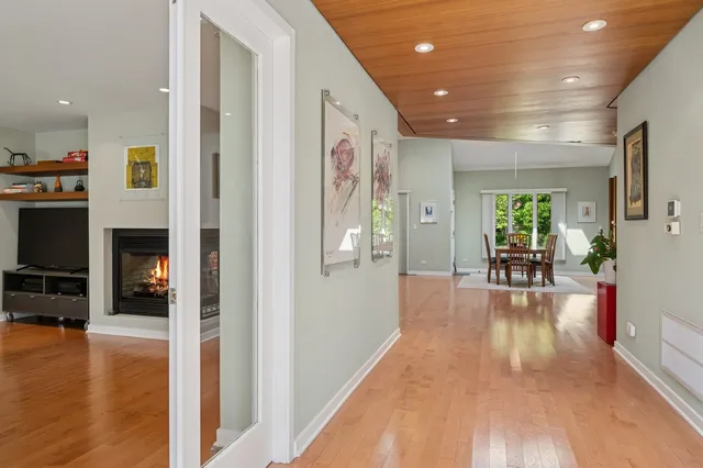 a view of a hallway with wooden floor windows and livingroom view