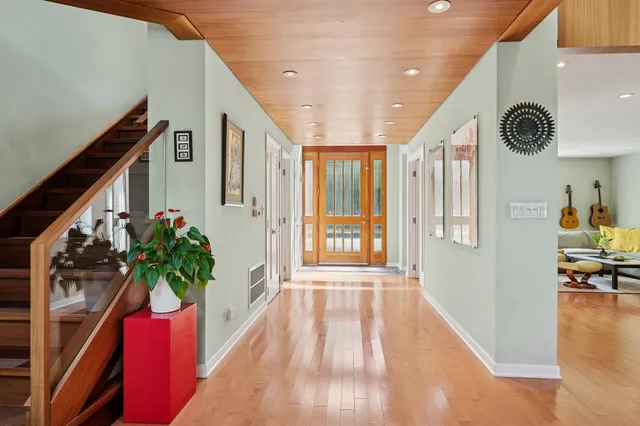 a view of entryway and hall with wooden floor