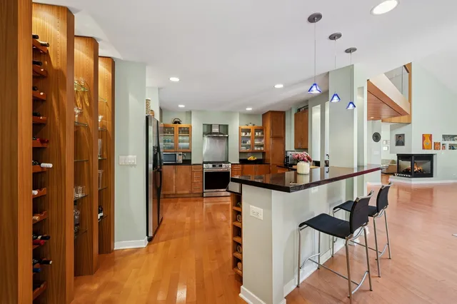 a kitchen with stainless steel appliances kitchen island granite countertop a refrigerator and microwave