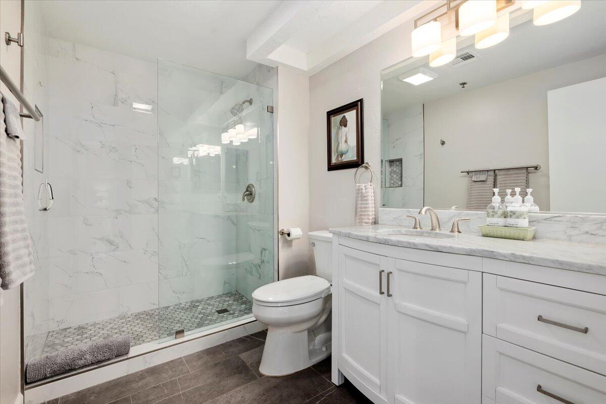 2700 Lawrence Crossley Road, Unit 10 Palm Springs, CA 92264 - Photo 11 of 15 a bathroom with a granite countertop sink a toilet and a mirror