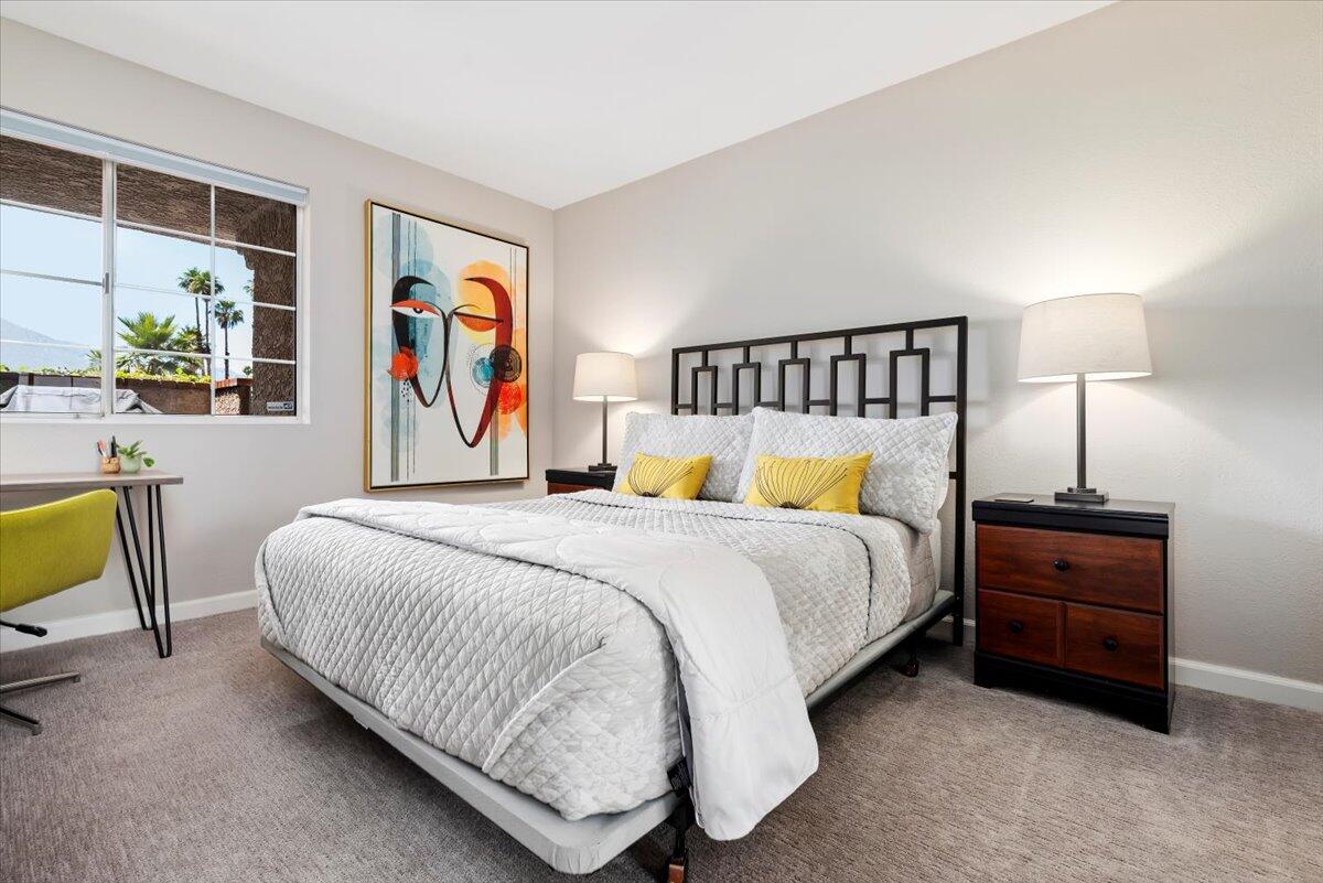 2700 Lawrence Crossley Road, Unit 10 Palm Springs, CA 92264 - Photo 14 of 15 a bedroom with a bed and a lamp with window