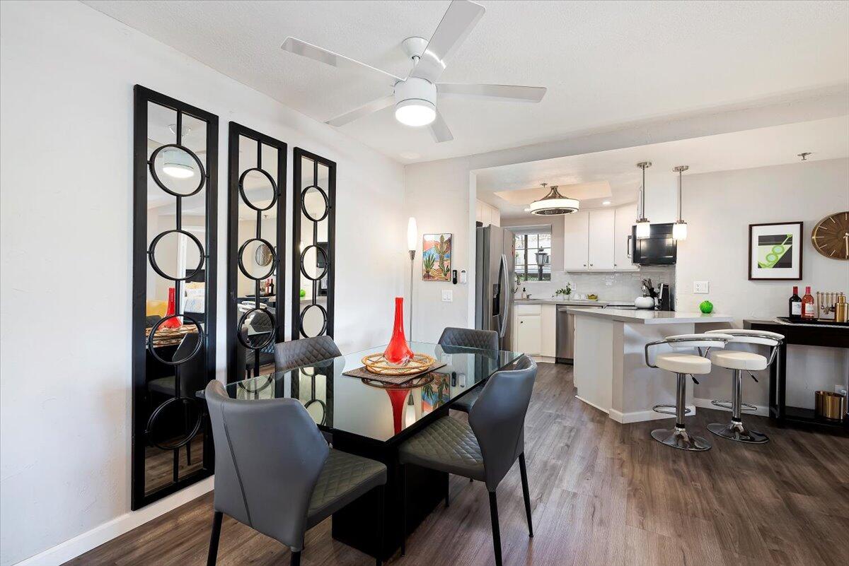 2700 Lawrence Crossley Road, Unit 10 Palm Springs, CA 92264 - Photo 6 of 15 a view of a dining room with furniture and wooden floor