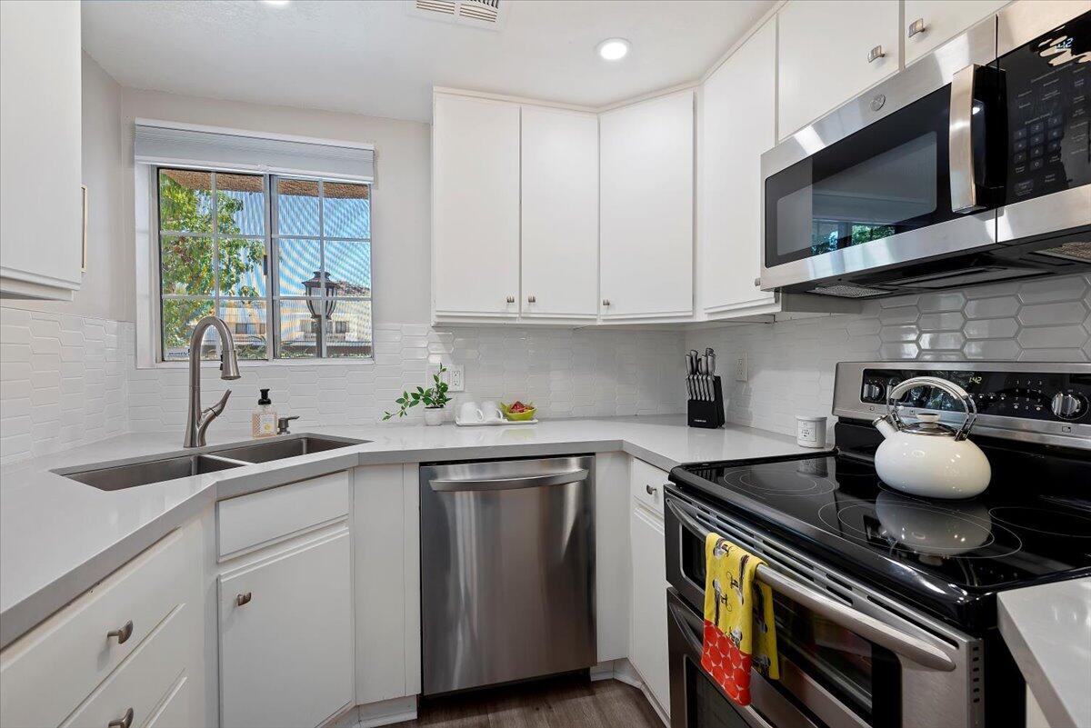 2700 Lawrence Crossley Road, Unit 10 Palm Springs, CA 92264 - Photo 7 of 15 a kitchen with a sink a stove and cabinets
