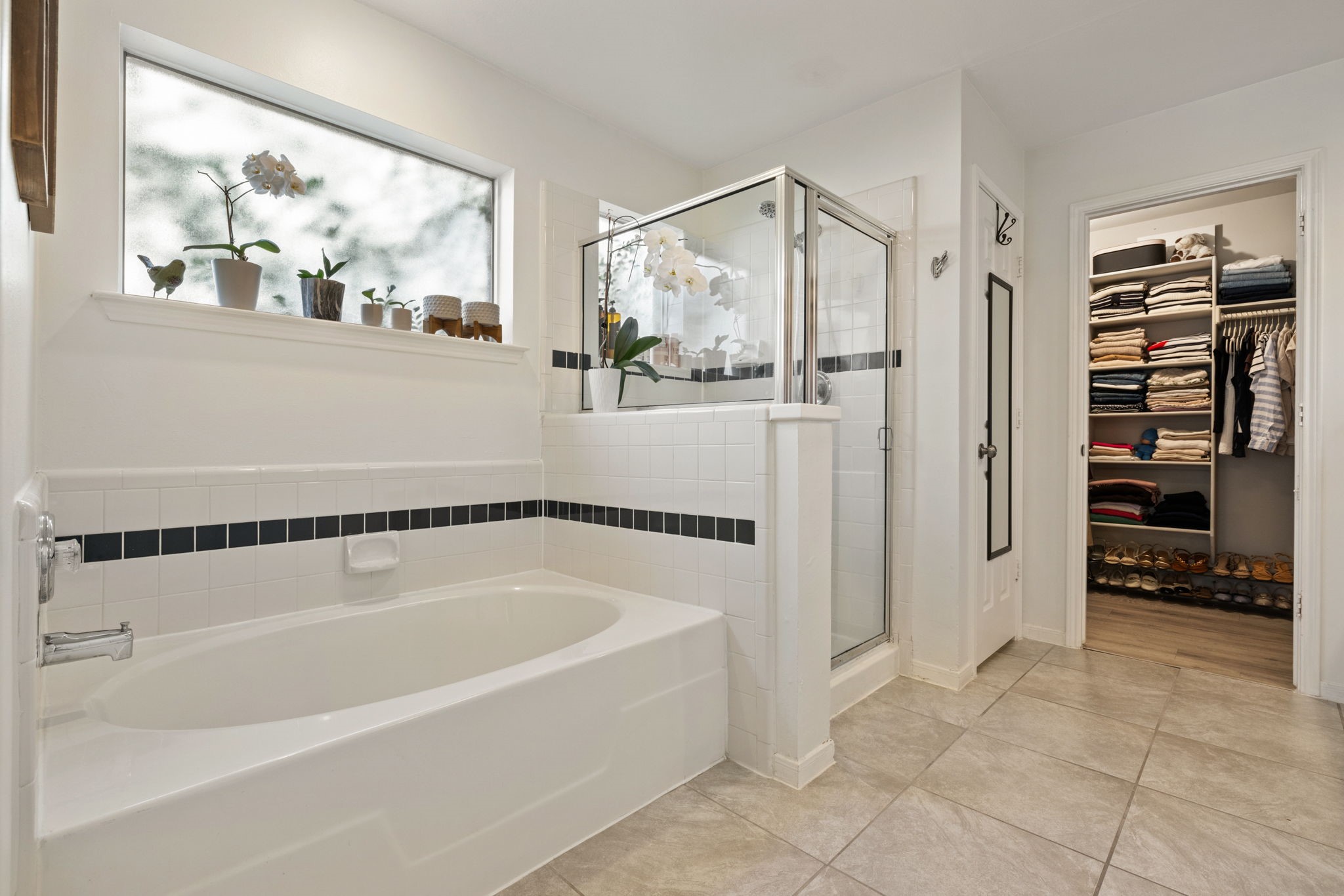 2106 Lexington Woods Drive Spring, TX 77373 - Photo 16 of 27 a bathroom with a bathtub and a shower