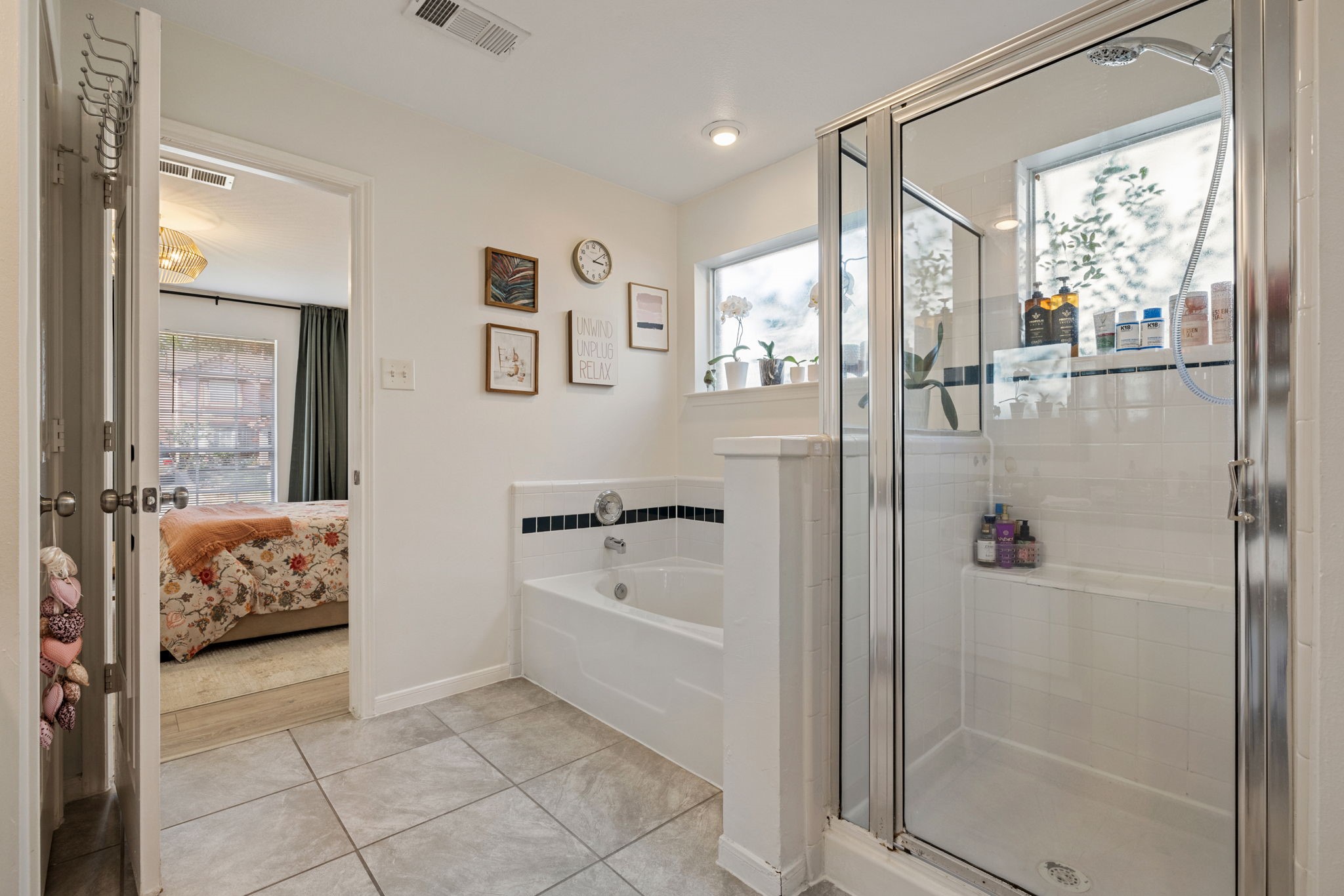2106 Lexington Woods Drive Spring, TX 77373 - Photo 18 of 27 a bathroom with a tub shower and mirror