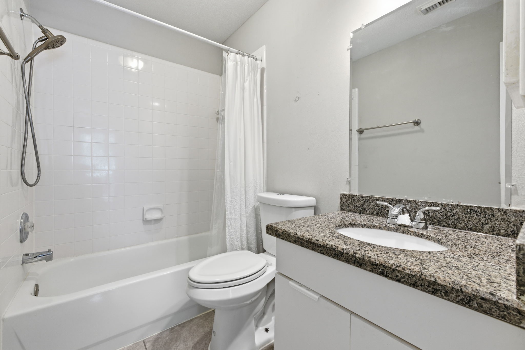 2106 Lexington Woods Drive Spring, TX 77373 - Photo 21 of 27 a bathroom with a granite countertop sink a toilet and shower