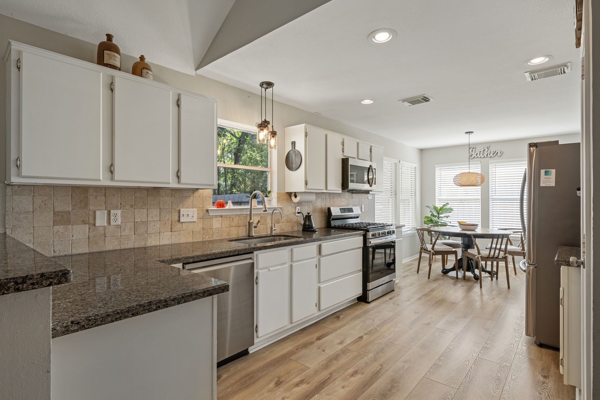 2106 Lexington Woods Drive Spring, TX 77373 - Photo 10 of 27 a kitchen with stainless steel appliances granite countertop sink microwave and wooden cabinets