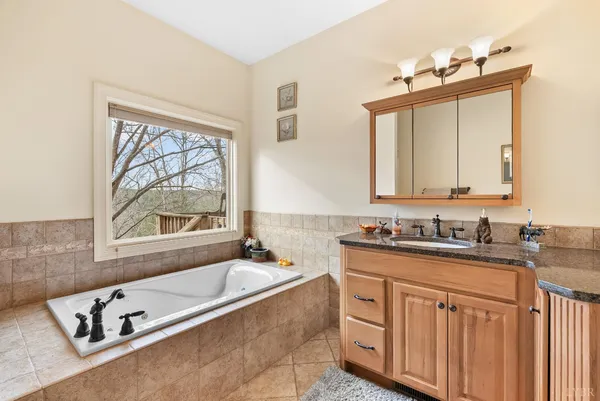 a bathroom with a bathtub and a window