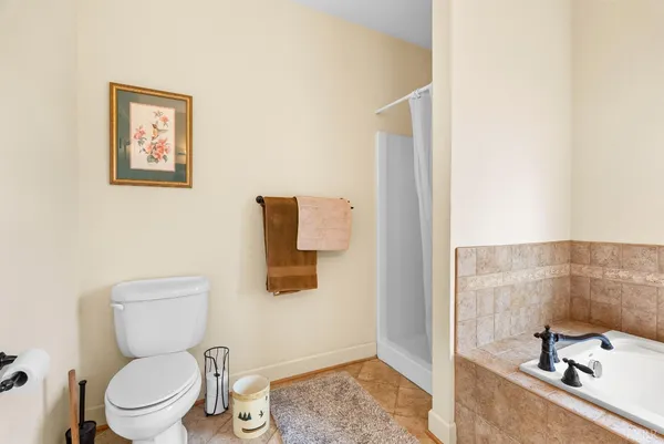 a living room with furniture a floor to ceiling windows and a ceiling fan
