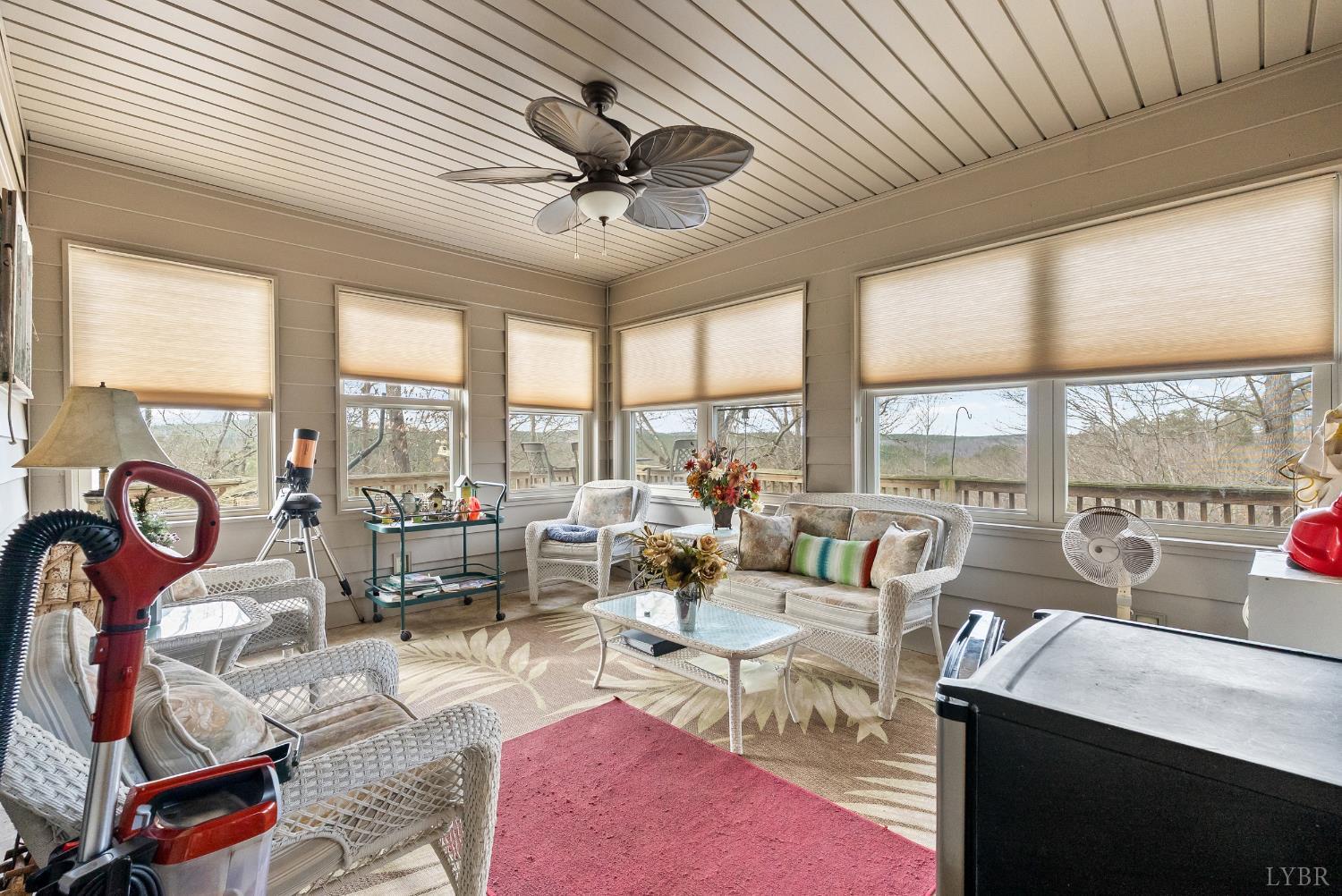 2481 School Crossing Road Lynch Station, VA 24571 - Photo 31 of 47 a living room with furniture a floor to ceiling windows and a ceiling fan