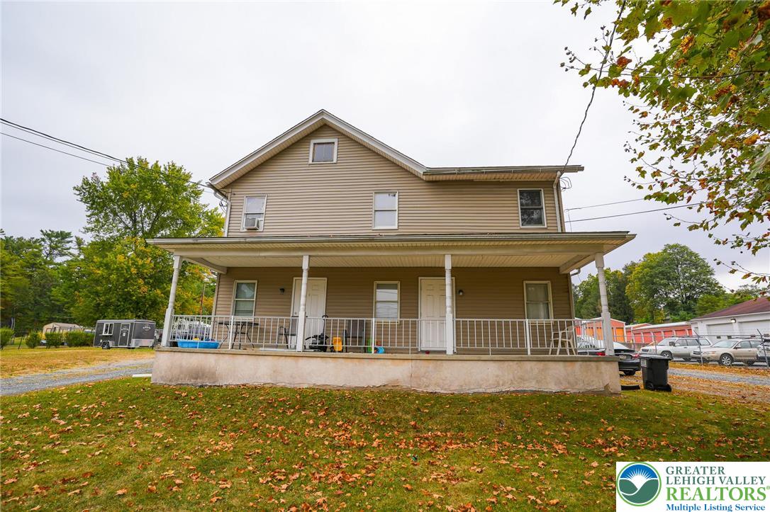 a view of a house with swimming pool and porch
